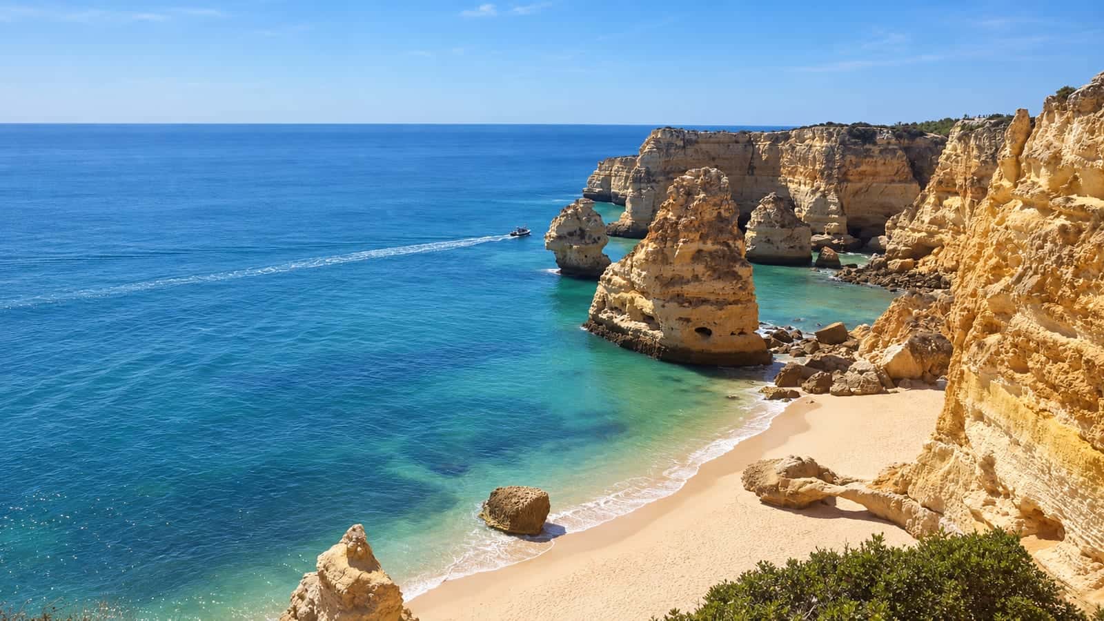 Golden limestone stacks and clear blue water at Praia da Marinha in Portugal’s Algarve