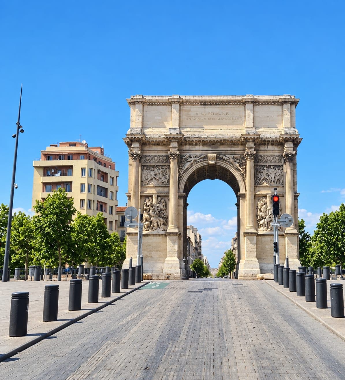 L’arc de pierre de la Porte d’Aix à Marseille, au bout d’une allée pavée sans passants
